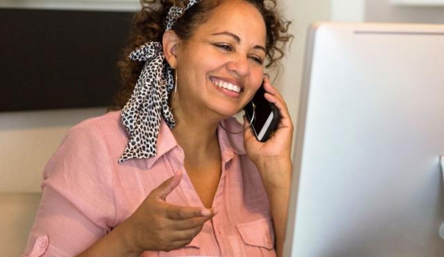 woman smiling at computer