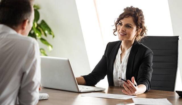 Woman at desk explaining