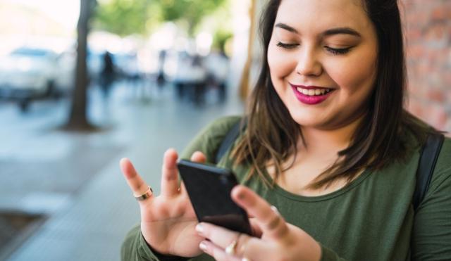 Woman checking her finances on her smart phone.