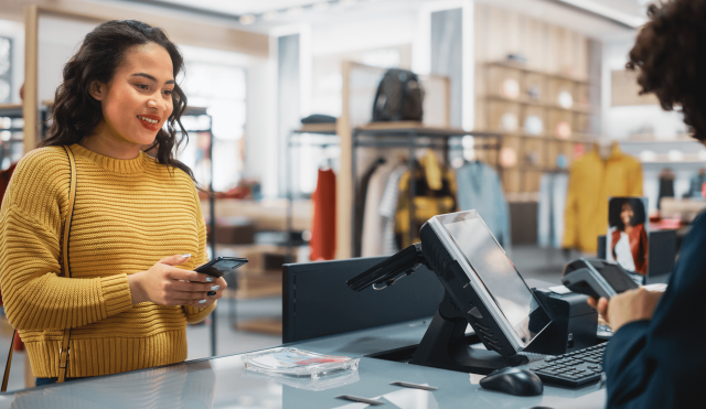 Woman paying at clothing store