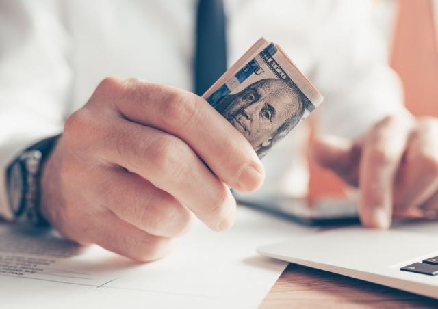 CLose up of person holding money.